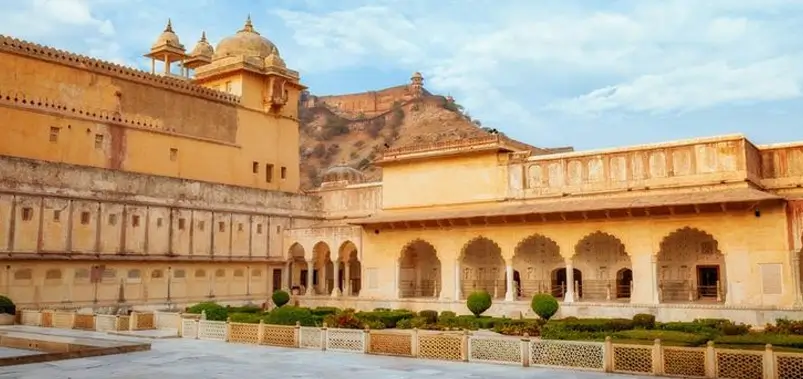 Scenic-view-of-historic-golden-palace-architecture-with-arched-corridors-and-manicured-gardens
